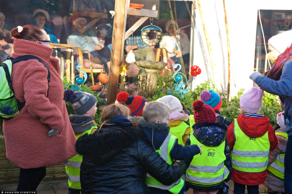 Little Elms Nursery children waving to Heaton House residents in Worthing